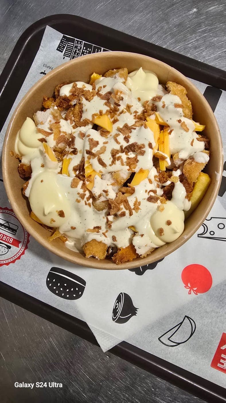 Bowl de frites nappé de sauce fromagère maison et de tenders